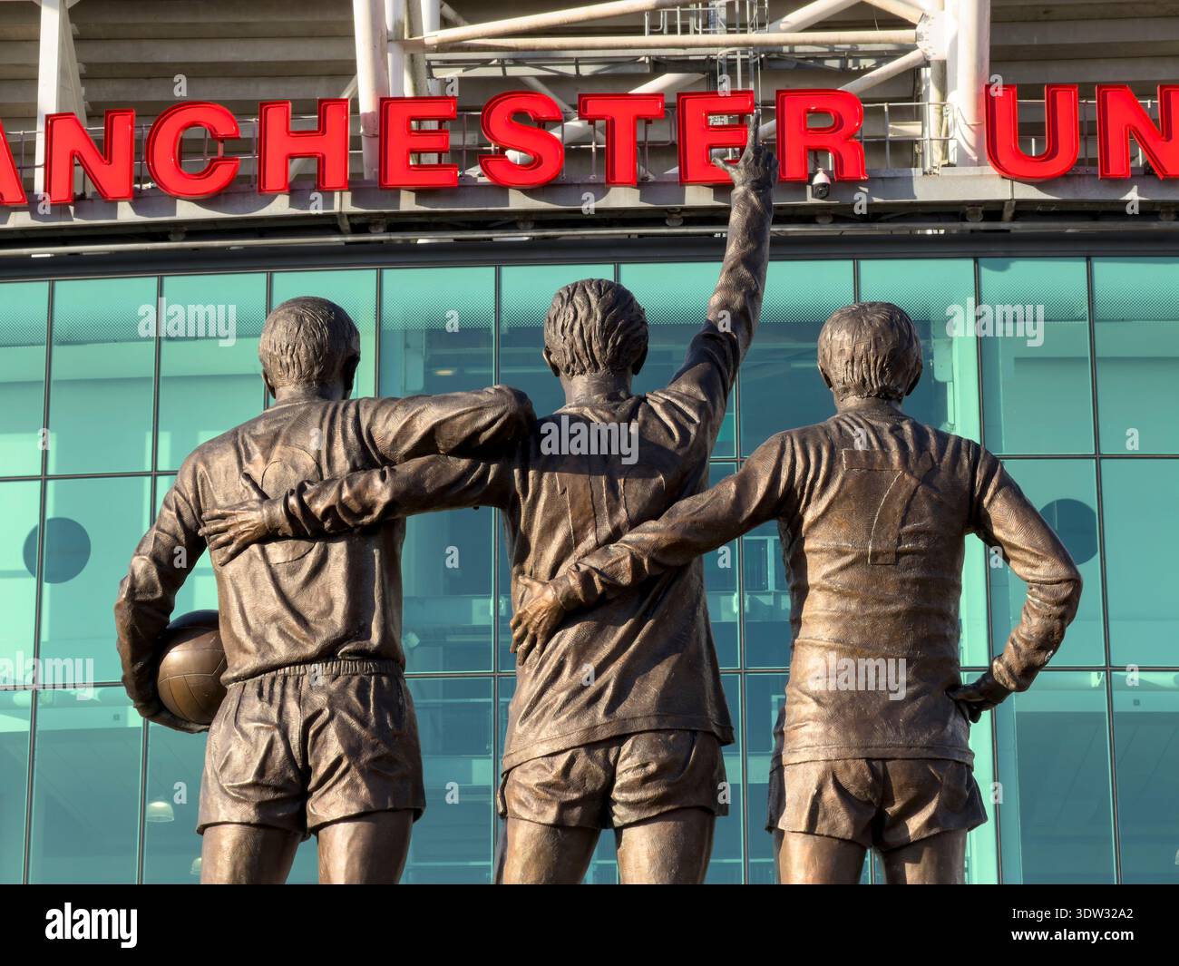 MANCHESTER, ENGLAND: FEBRUARY 17, 2026: Close up of three memorial statues outside Old Trafford stadium - Smartphone Captured Stock Image