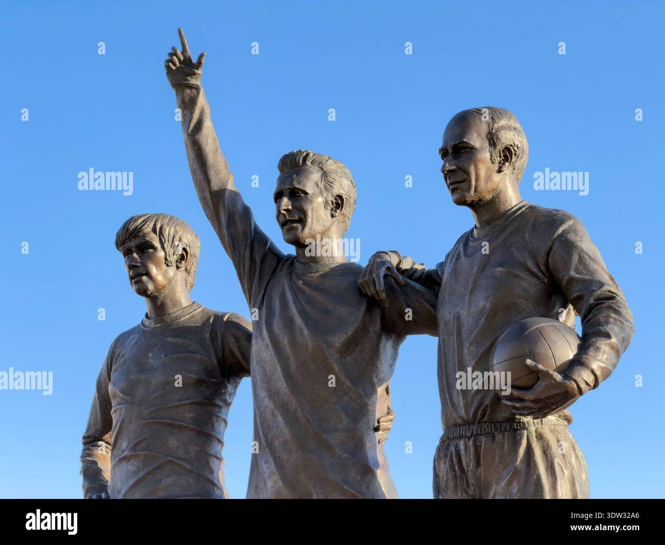 MANCHESTER, ENGLAND: FEBRUARY 17, 2026: Three bronze statues of George Best, Denis Law and Sir Bobby Charlton (United Trinity) at Old Trafford - Smartphone Captured Stock Image