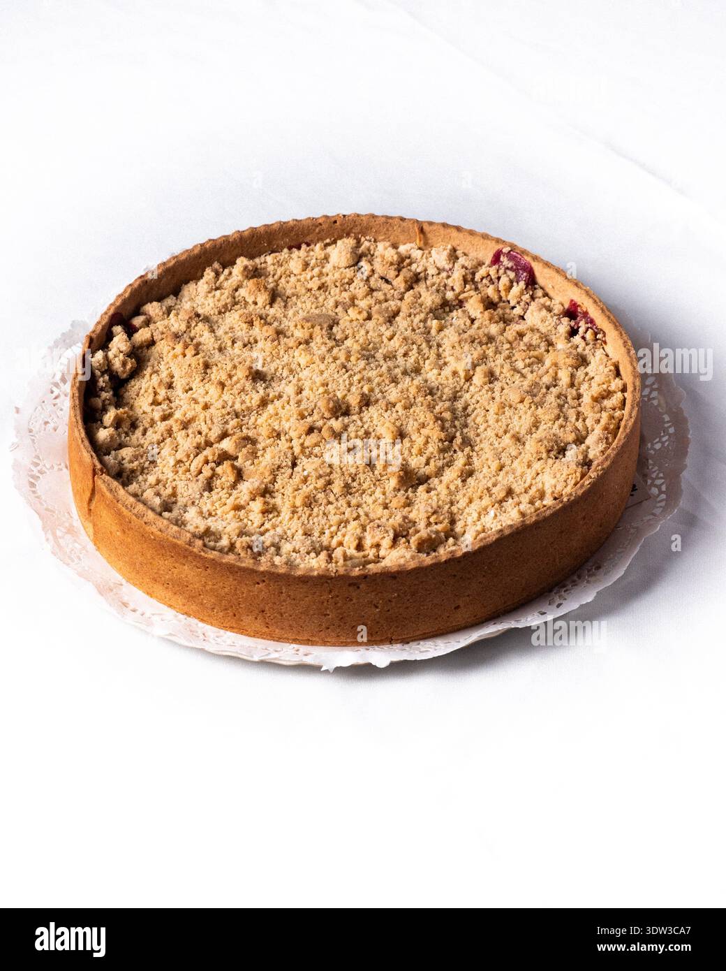 Cherry kuchen on a table with a white tablecloth Stock Photo