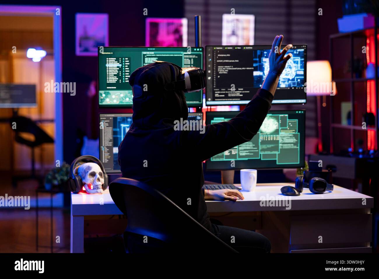 Hacker wearing VR headset uses AI machine learning to develop zero day exploit undetectable by antivirus. Rogue engineer uses virtual reality and neural networks to build script doing data mining Stock Photo