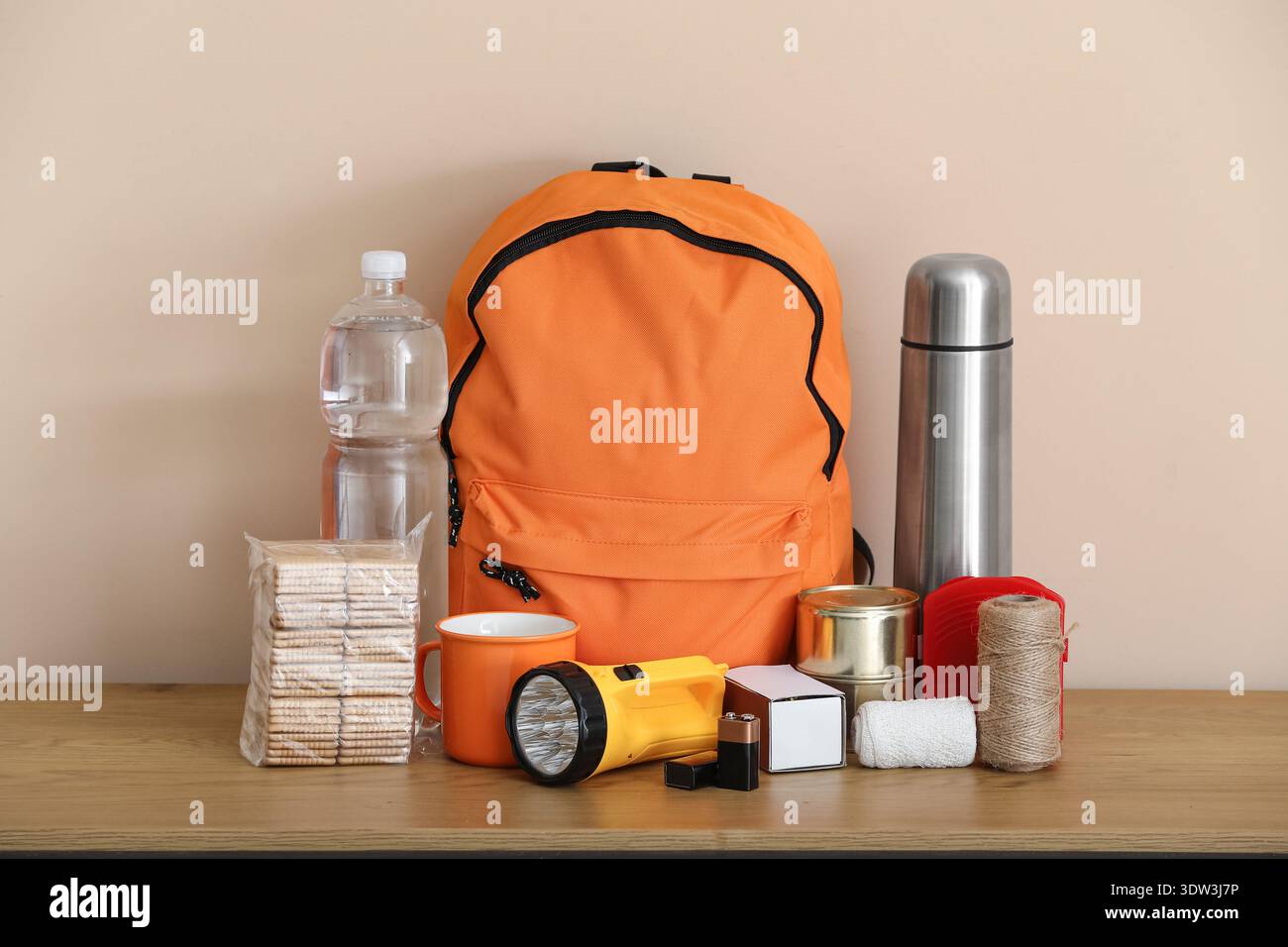 Emergency backpack and necessities on table at home Stock Photo