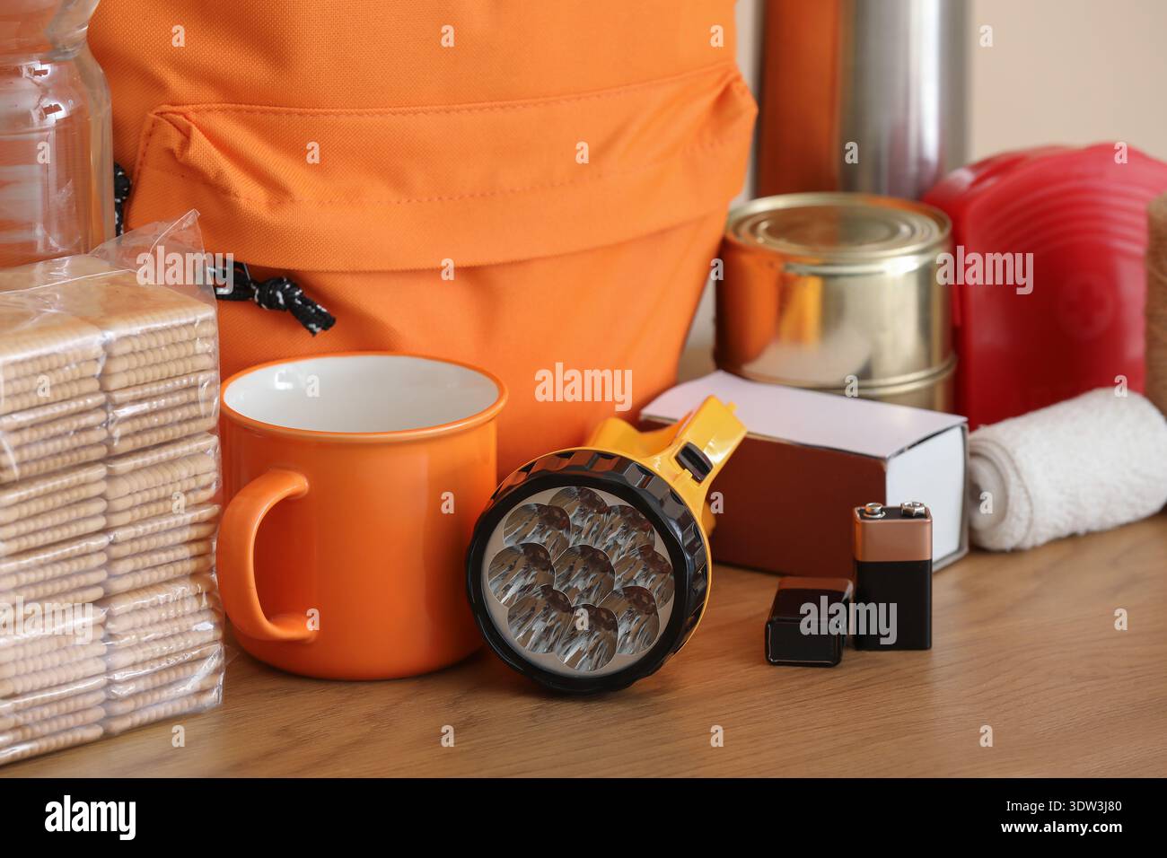 Emergency backpack and necessities on table at home Stock Photo