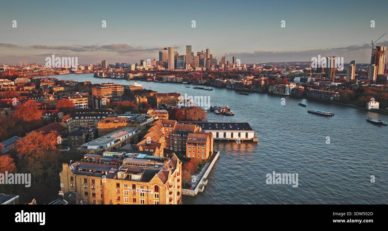 London skyline at golden sunset hour with River Thames winding past ...