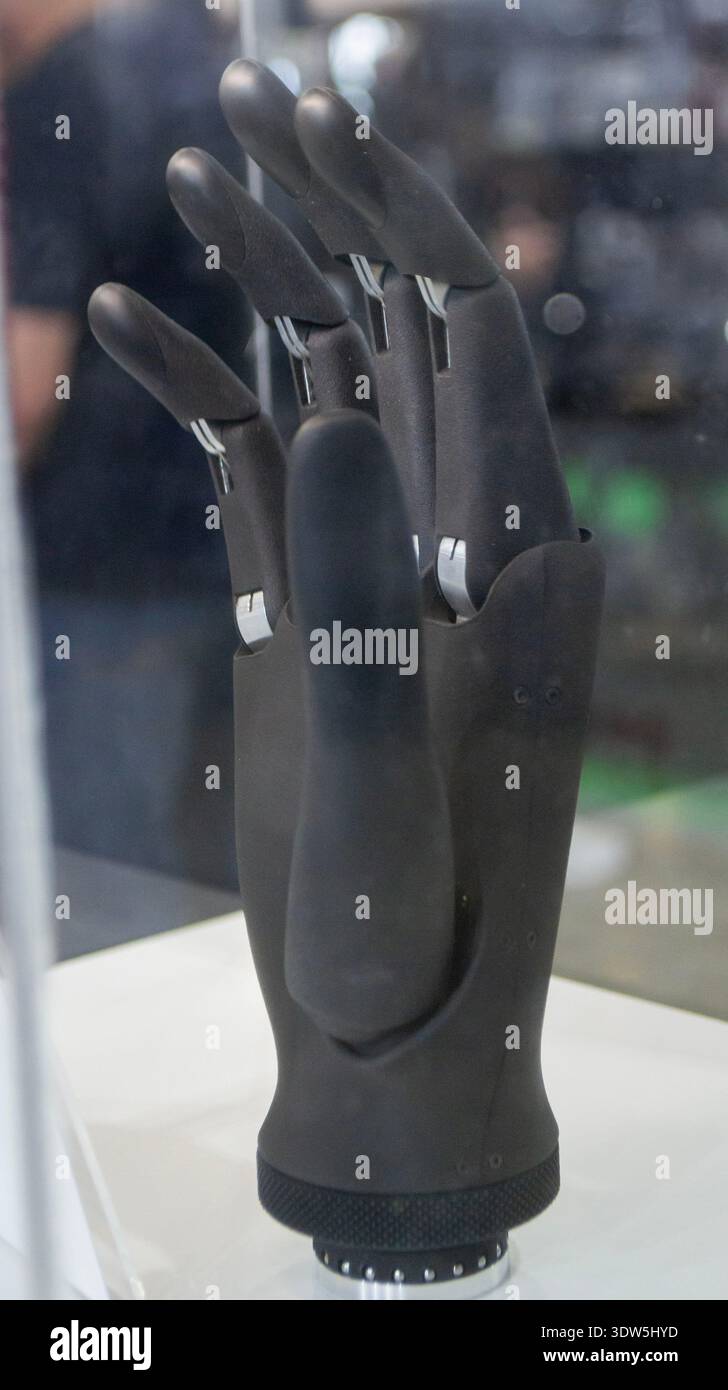 Bionic arm prosthesis. Plastic prosthesis printed on a 3D printer. Robotic arm. Robotics prosthesis for hand printed on a 3D printer from plastic powder. Modern new innovation medicine technologies. Stock Photo