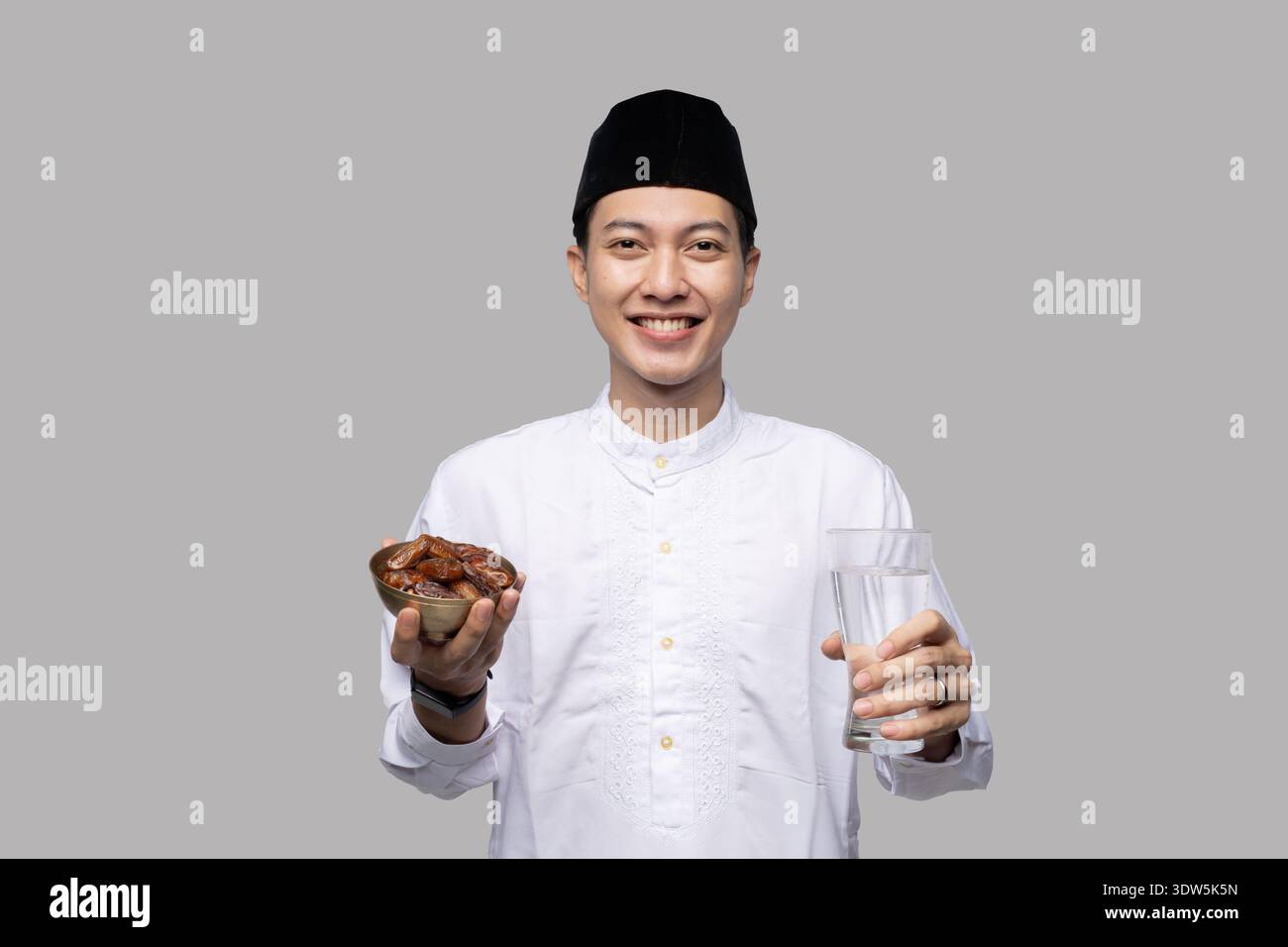 Portrait of cheerful Asian man offering nutritious drinks and water Stock Photo