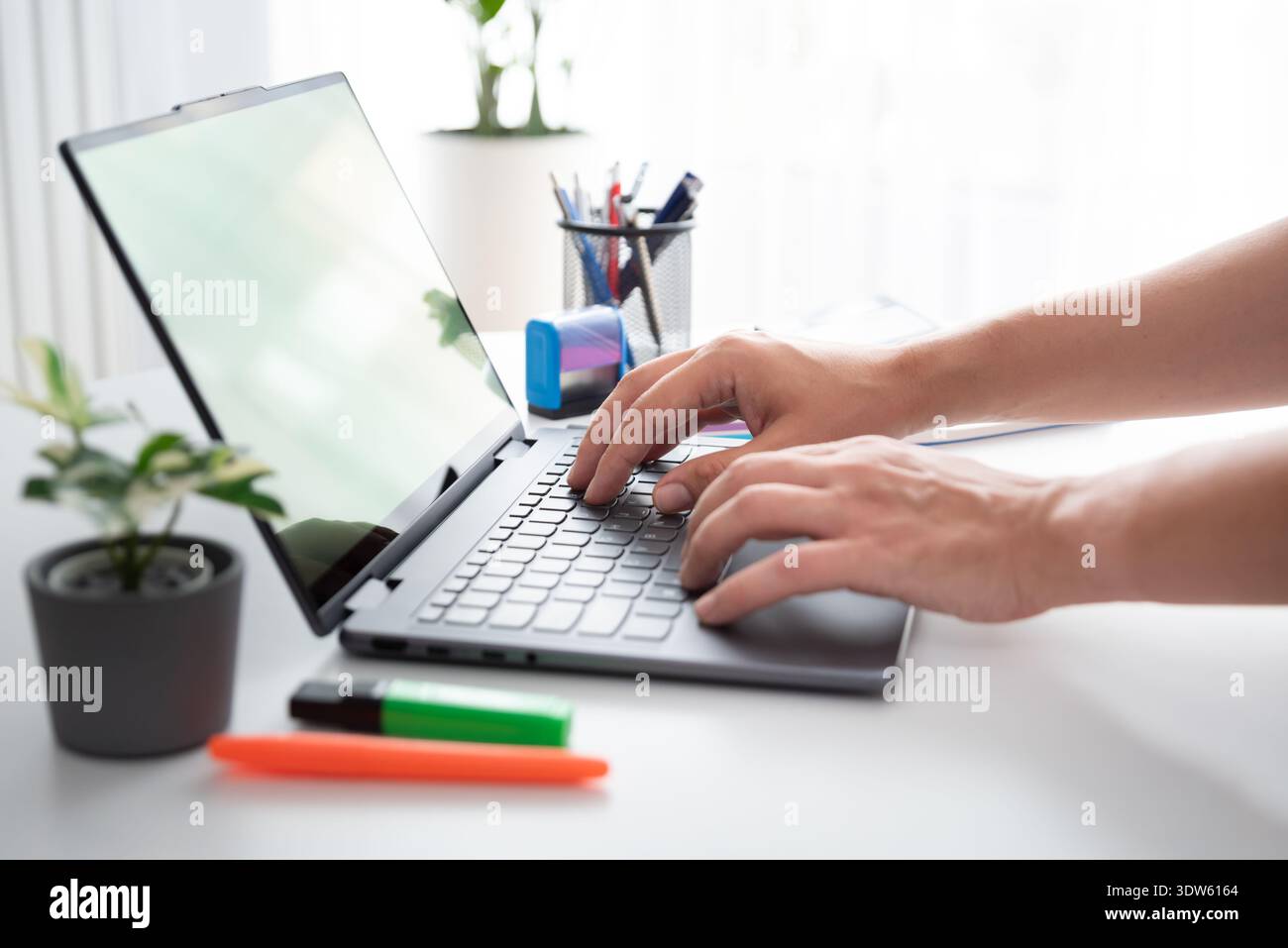 Man using laptop with blank screen, copy space Stock Photo