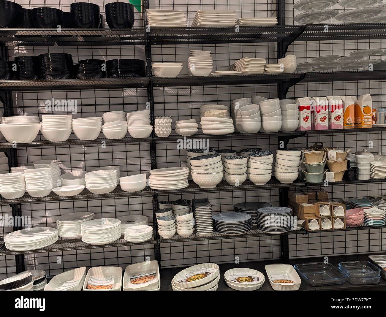 Pforzheim Germany Februar 25, 2026 Stacked White Ceramic Bowls And Plates Arranged On Matte Black Shelving, Clean Minimalist Tableware Stock Photo