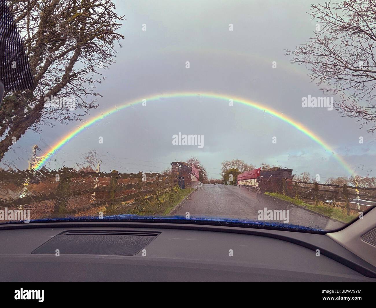 Full arc rainbow seen through a car windscreen. - Smartphone Captured Stock Image