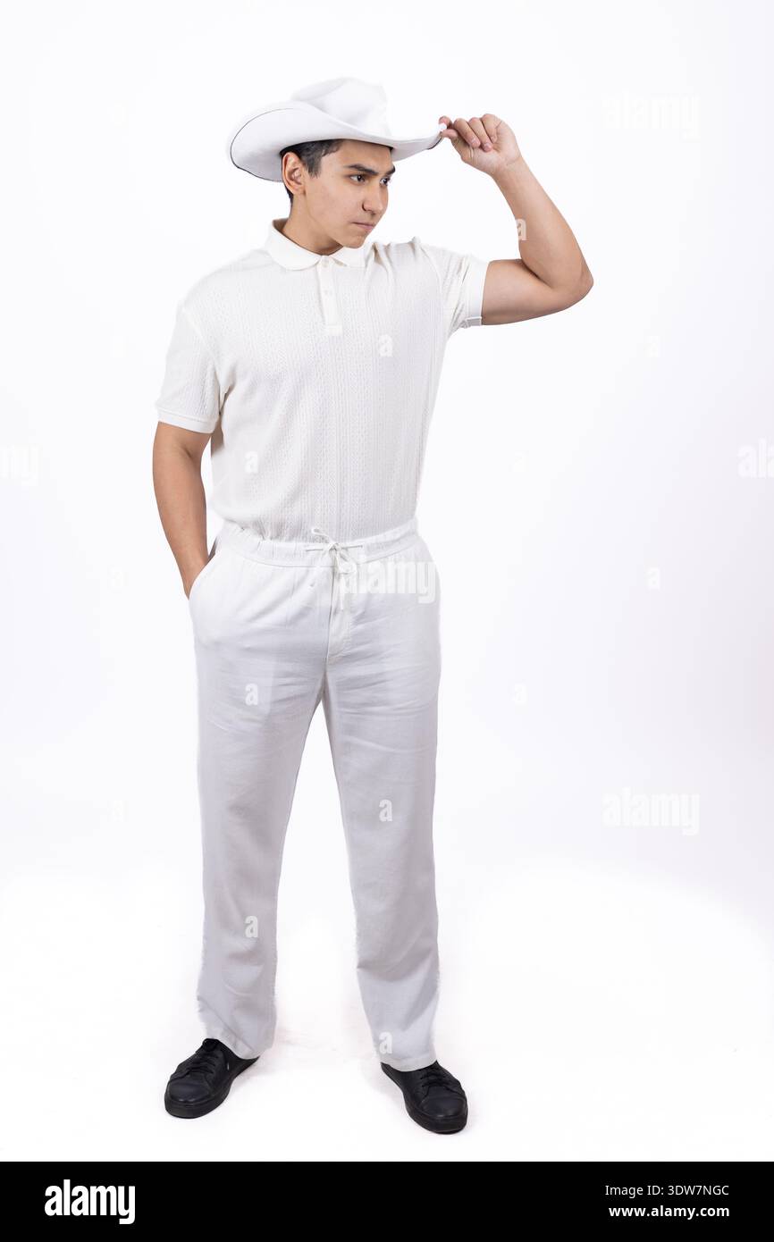 Man in white uniform and chef hat posing in studio Stock Photo