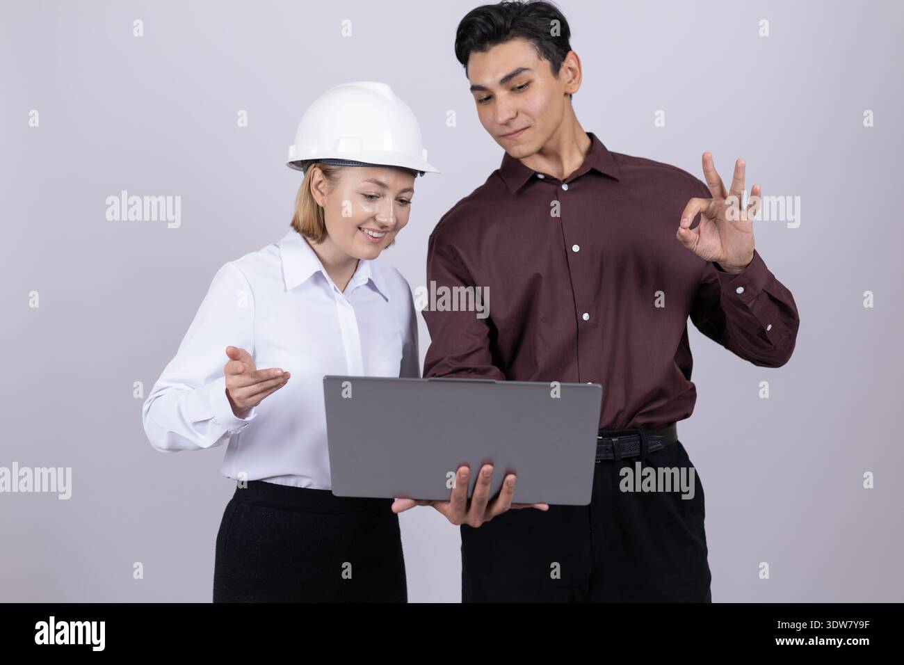 Two workers in formal shirts using laptop in studio Stock Photo