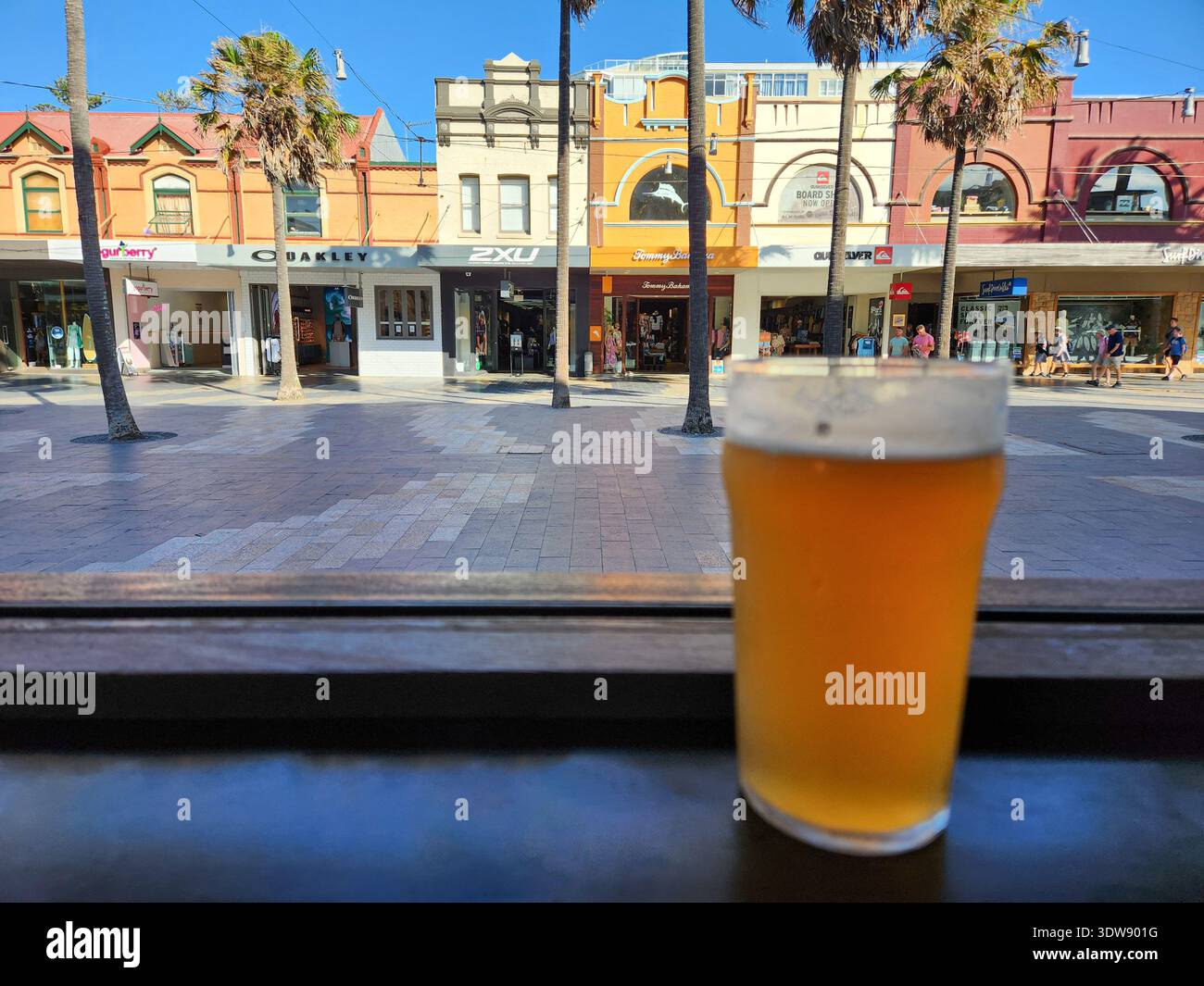 A pint of beer on a window sill with the Manyl Corso in the background on a summer afternoon - Smartphone Captured Stock Image