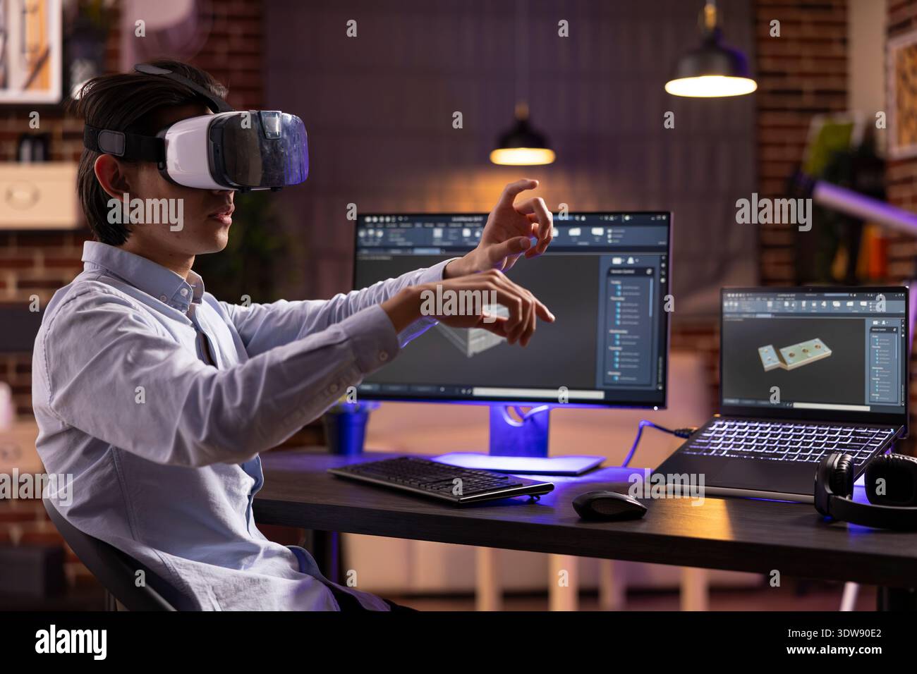 Remote worker wearing VR headset, designs mechanical prototypes using cad software. Creative developer combines virtual reality technology with computer modeling for advanced product visualization. Stock Photo