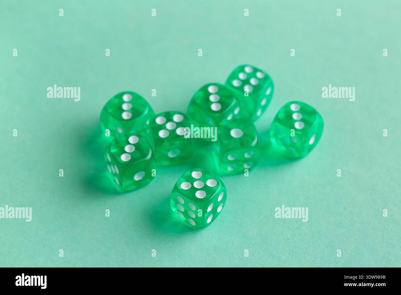 Green game dices on turquoise background Stock Photo
