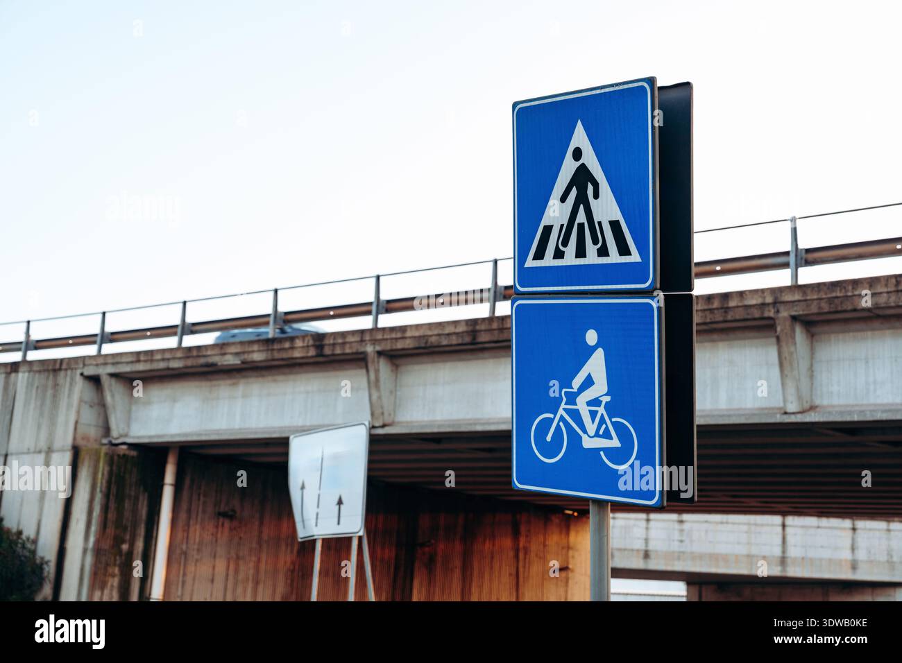 Overpass Signage Traffic signs show pedestrian and bicycle paths near a highway overpass ...