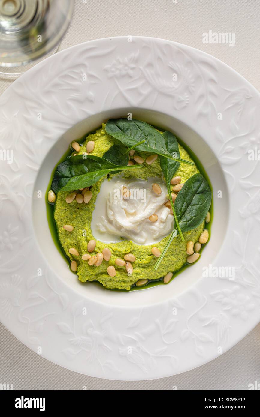 Spinach cream mousse with burrata and pine nuts Stock Photo