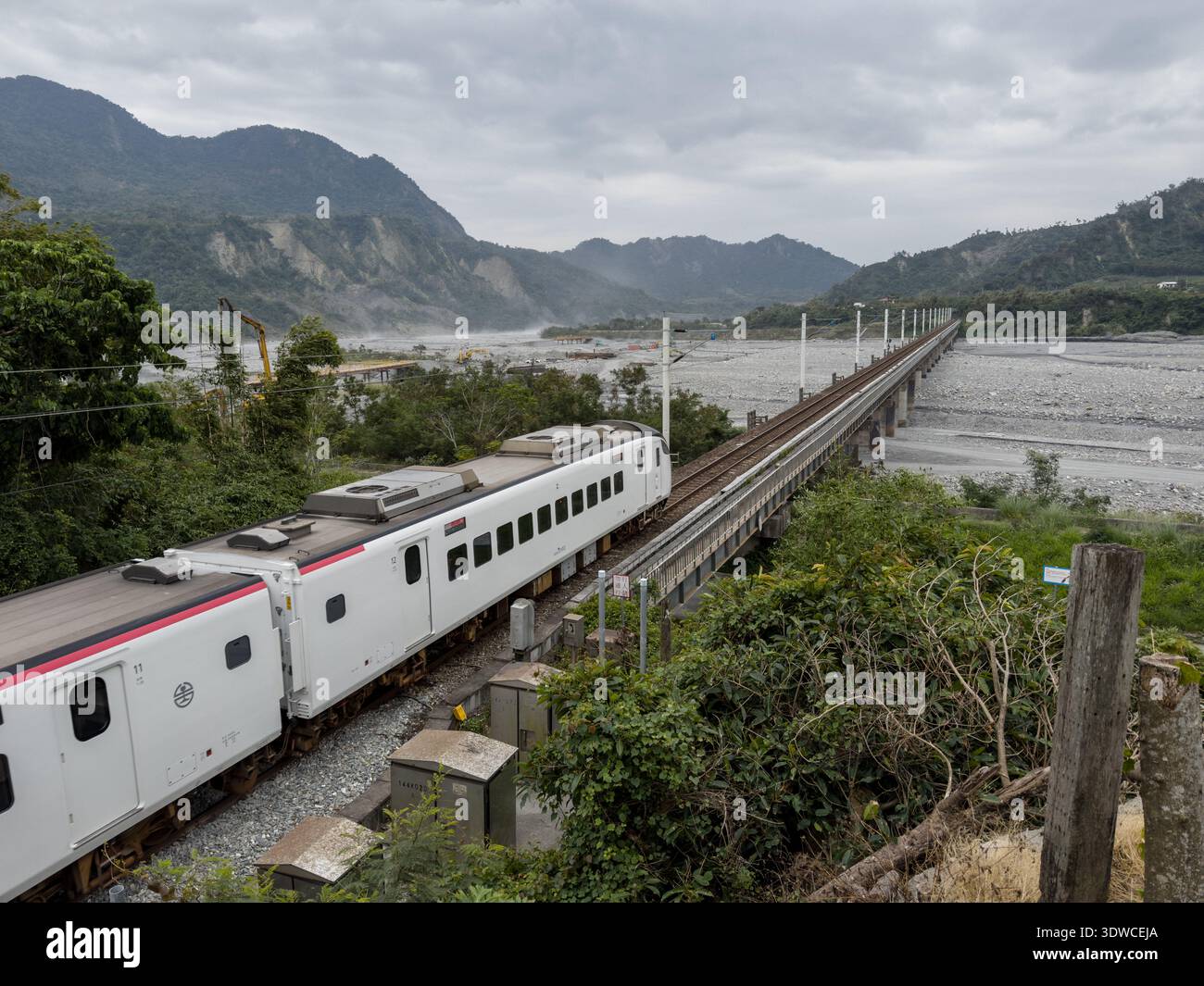 Taiwan Railway (TR) EMU3000 series Tze-Chiang, aka Tzu-chiang, Limited Express ED3101 train front car passing by the Coastal Range (L) and Luye River - Smartphone Captured Stock Image