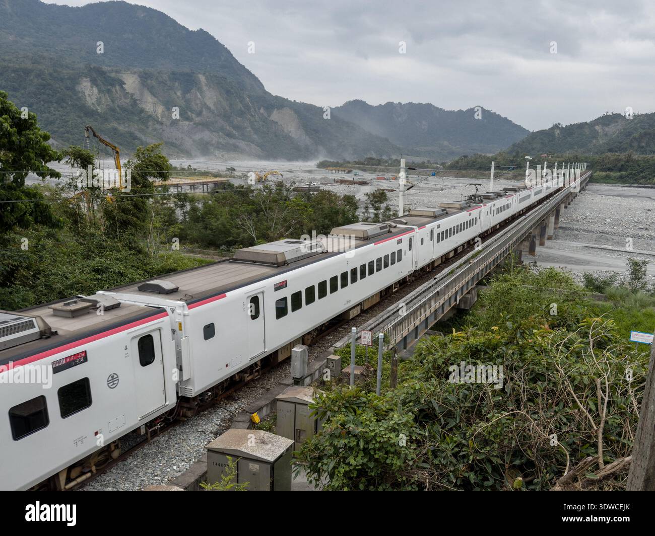 Taiwan Railway (TR) EMU3000 series Tze-Chiang, aka Tzu-chiang, Limited Express ED3101 train front car passing by the Coastal Range (L) and Luye River - Smartphone Captured Stock Image
