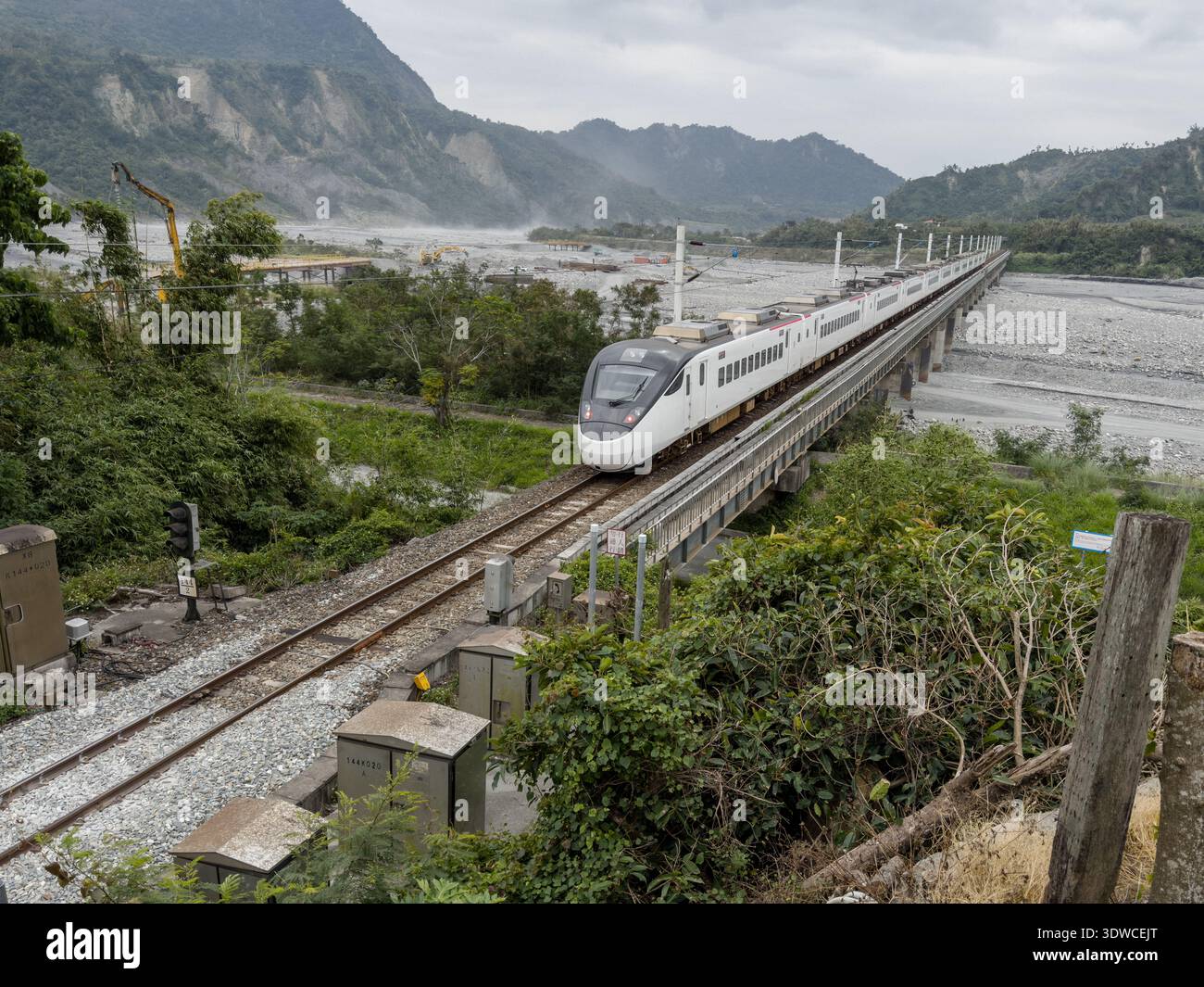 Taiwan Railway (TR) EMU3000 series Tze-Chiang, aka Tzu-chiang, Limited Express ED3101 train rear car passing by the Coastal Range (L) and Luye River a - Smartphone Captured Stock Image