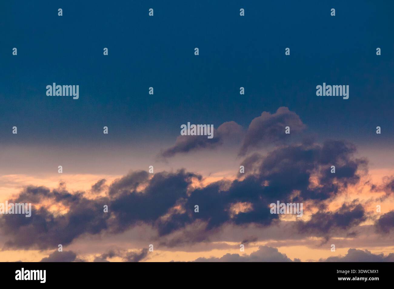 dramatic storm sky with clouds at sunset. dark blue cloudy background at dusk. bad weather forecast during spring. deep moody tones. meteorology air p Stock Photo