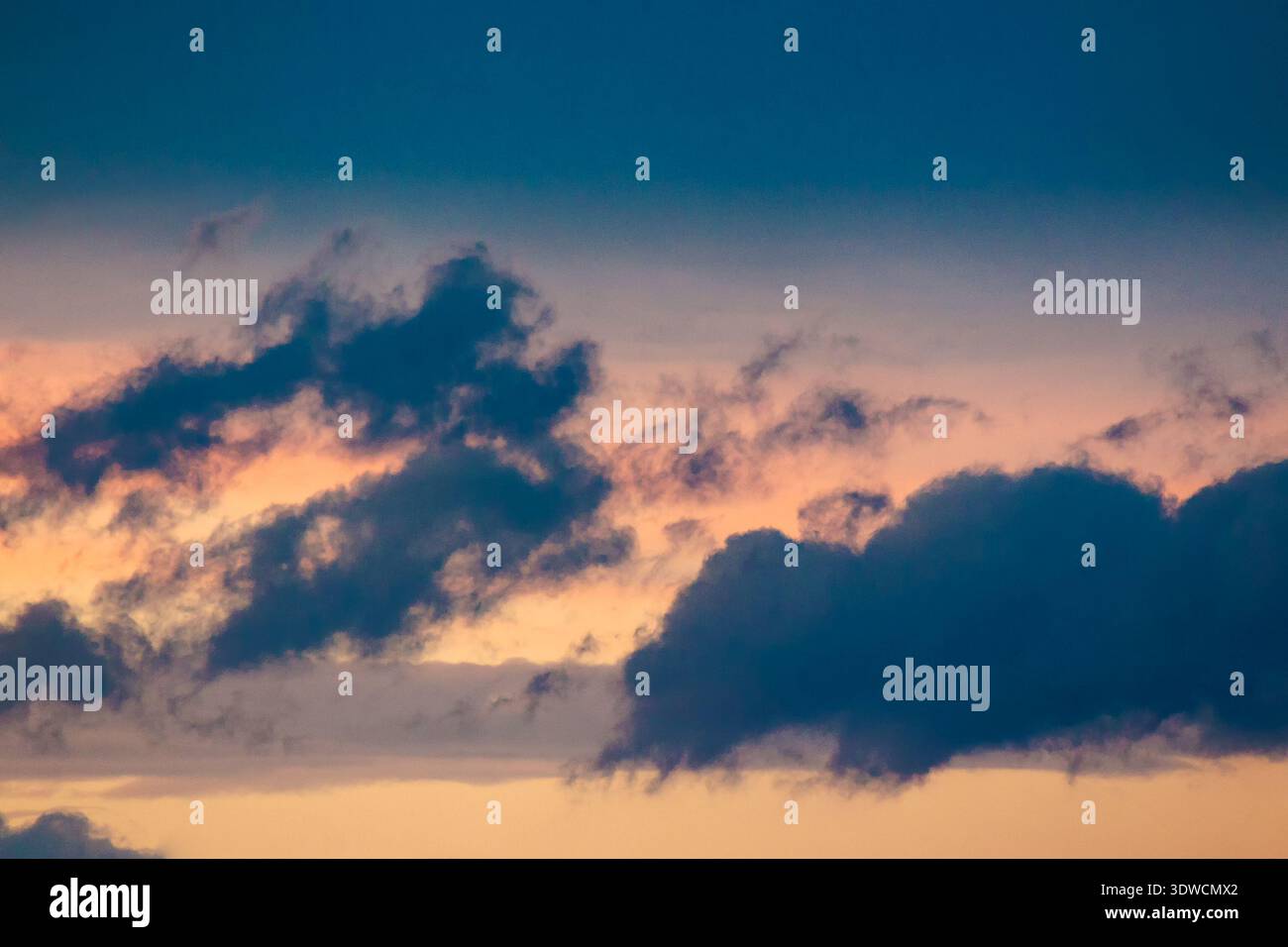 dramatic storm sky with clouds at sunset. dark blue cloudy background at dusk. bad weather forecast during spring. deep moody tones. meteorology air p Stock Photo