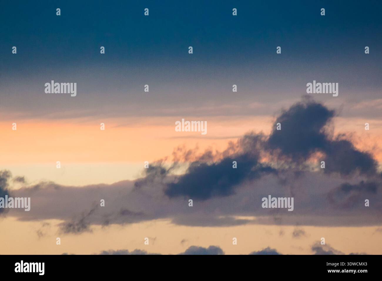 dramatic storm sky with clouds at sunset. dark blue cloudy background at dusk. bad weather forecast during spring. deep moody tones. meteorology air p Stock Photo