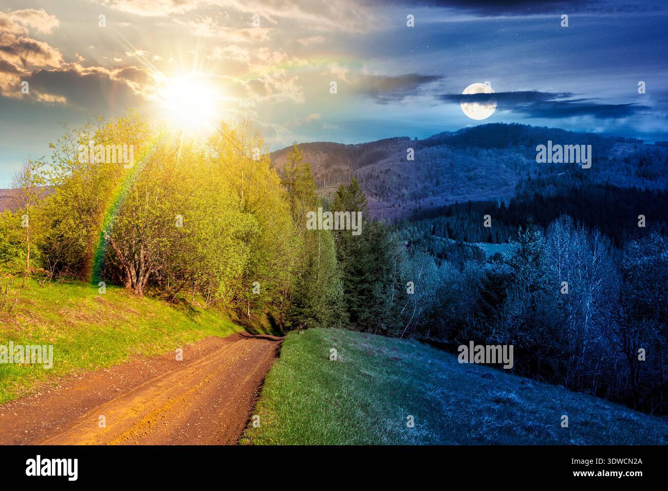 beautiful mountain landscape with dirt road. day meet night. sun and moon over forest path through grassy hills in spring. rural transportation in gre Stock Photo