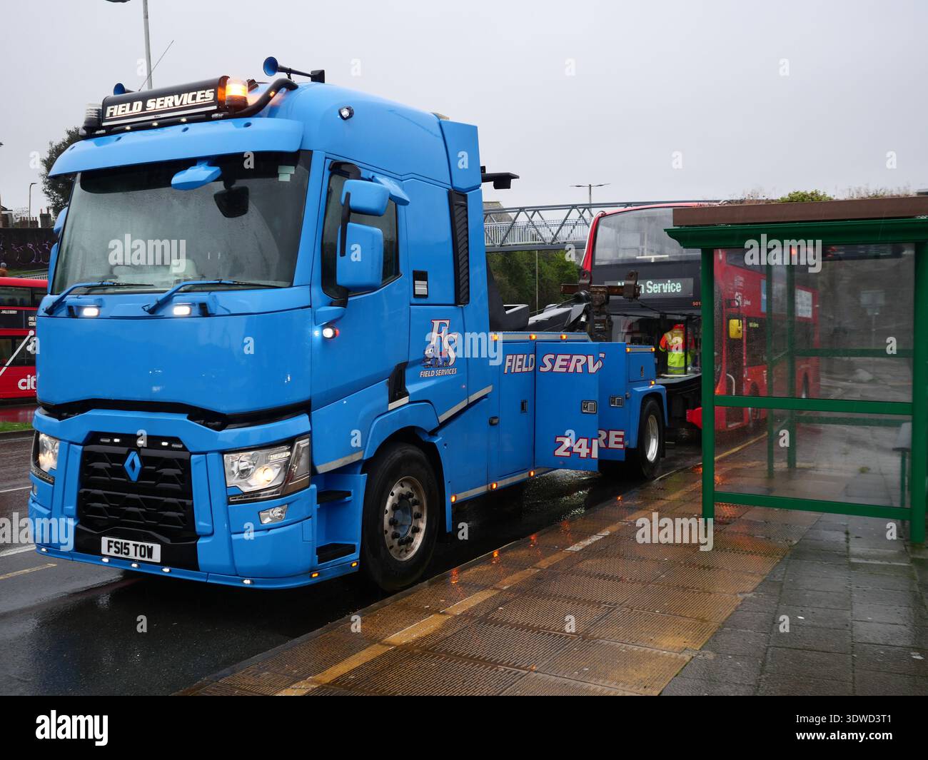 Breakdown recovery truck with a Bus broken down at bus stop. Plymouth ...