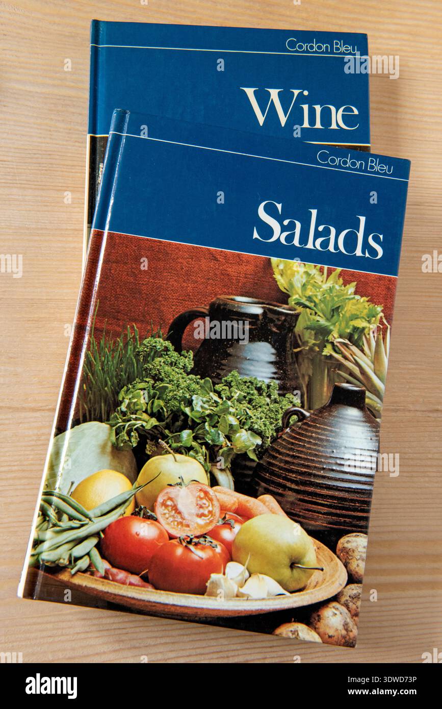 Two Cordon Bleu Cookery Books, one on Salads the other Wine on wooden kitchen table Stock Photo