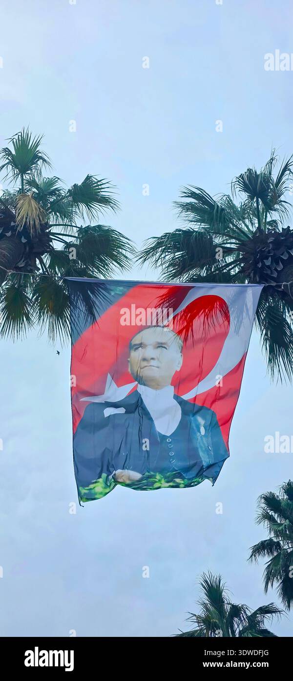 Marmaris, Turkey - April 22, 2025: . Turkish flag with Ataturk's image is displayed between palm trees outdoors - Smartphone Captured Stock Image