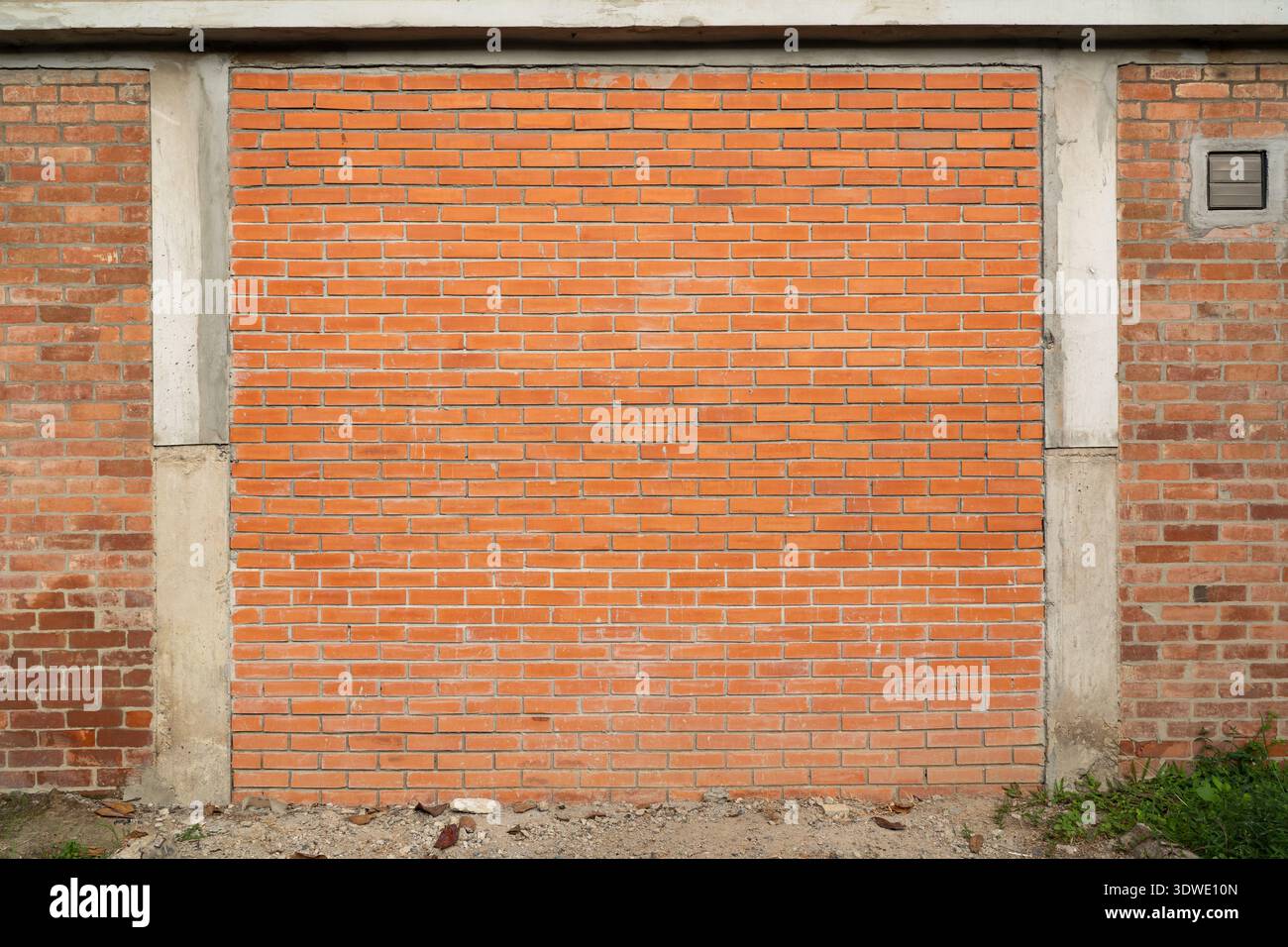 Orange brick wall with concrete columns Stock Photo