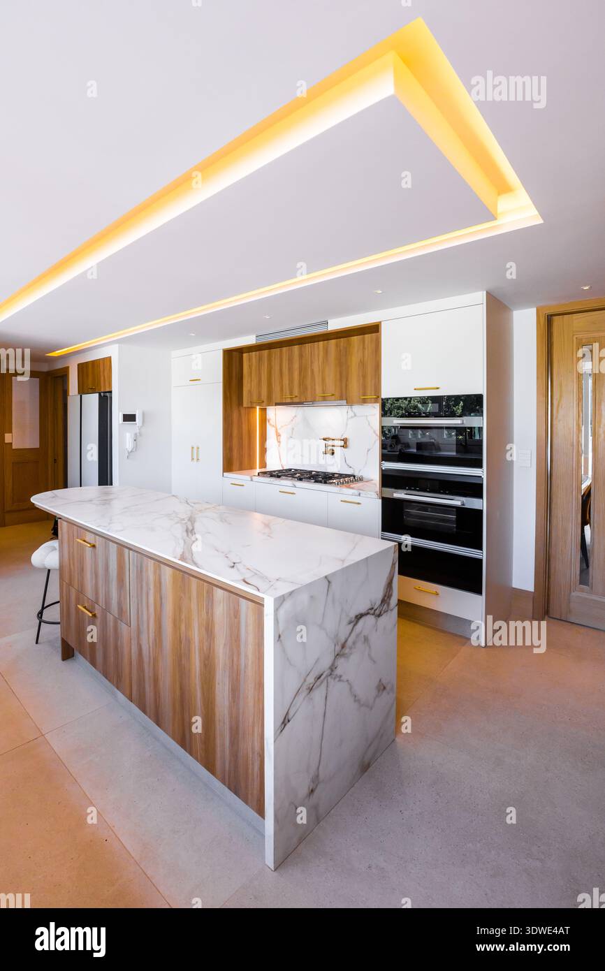 Minimalist luxury kitchen with a modern kitchen island, featuring sleek ...