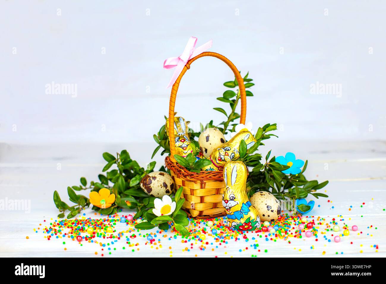 Easter composition. decorated with Easter bread and Easter eggs on the table decorated with herbs and chocolate hare Stock Photo