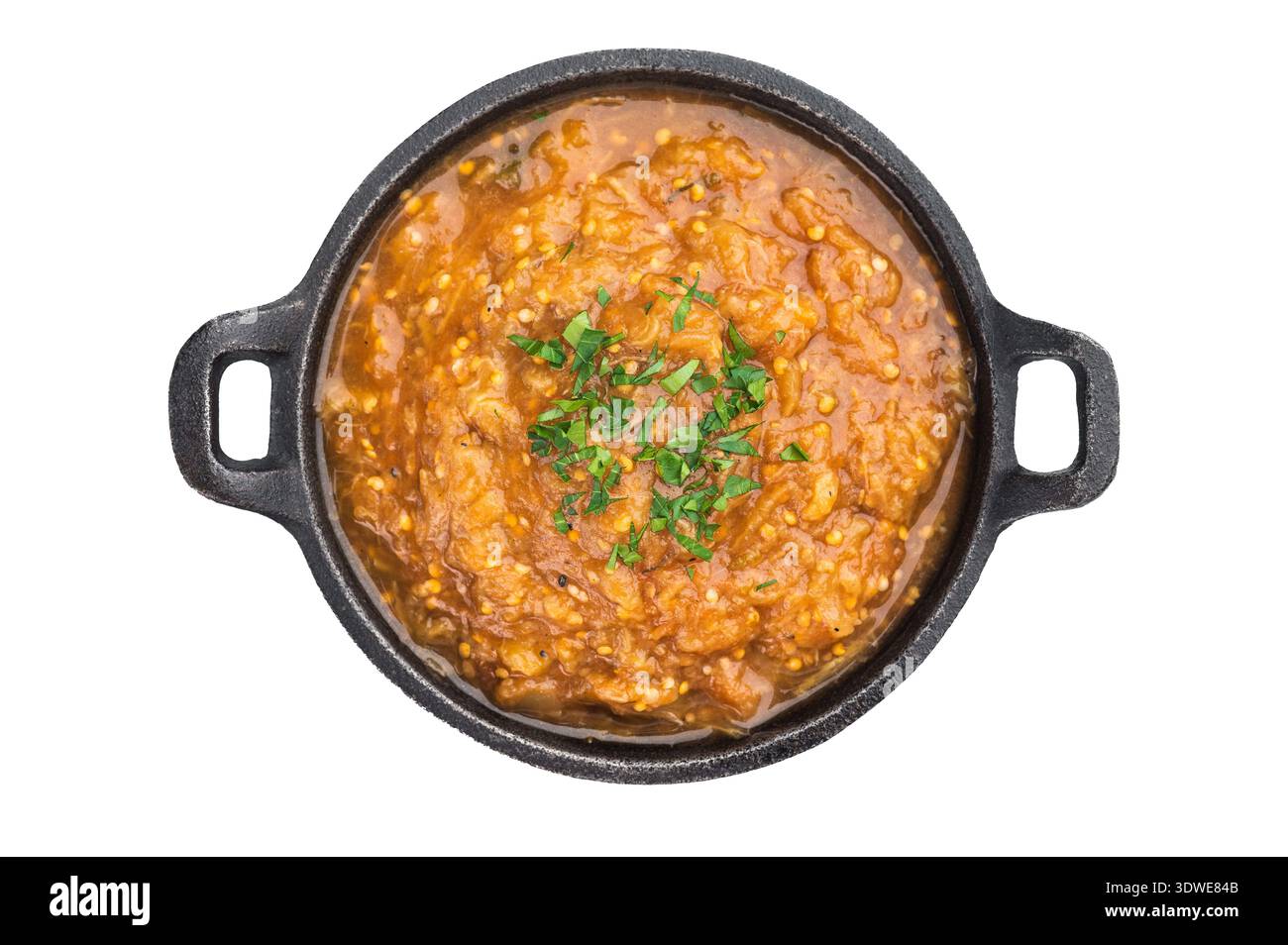 Balkan Mediterranean kyopolou eggplant caviar puree homemade vegetable relish presented in iron skillet on isolated background. Stock Photo