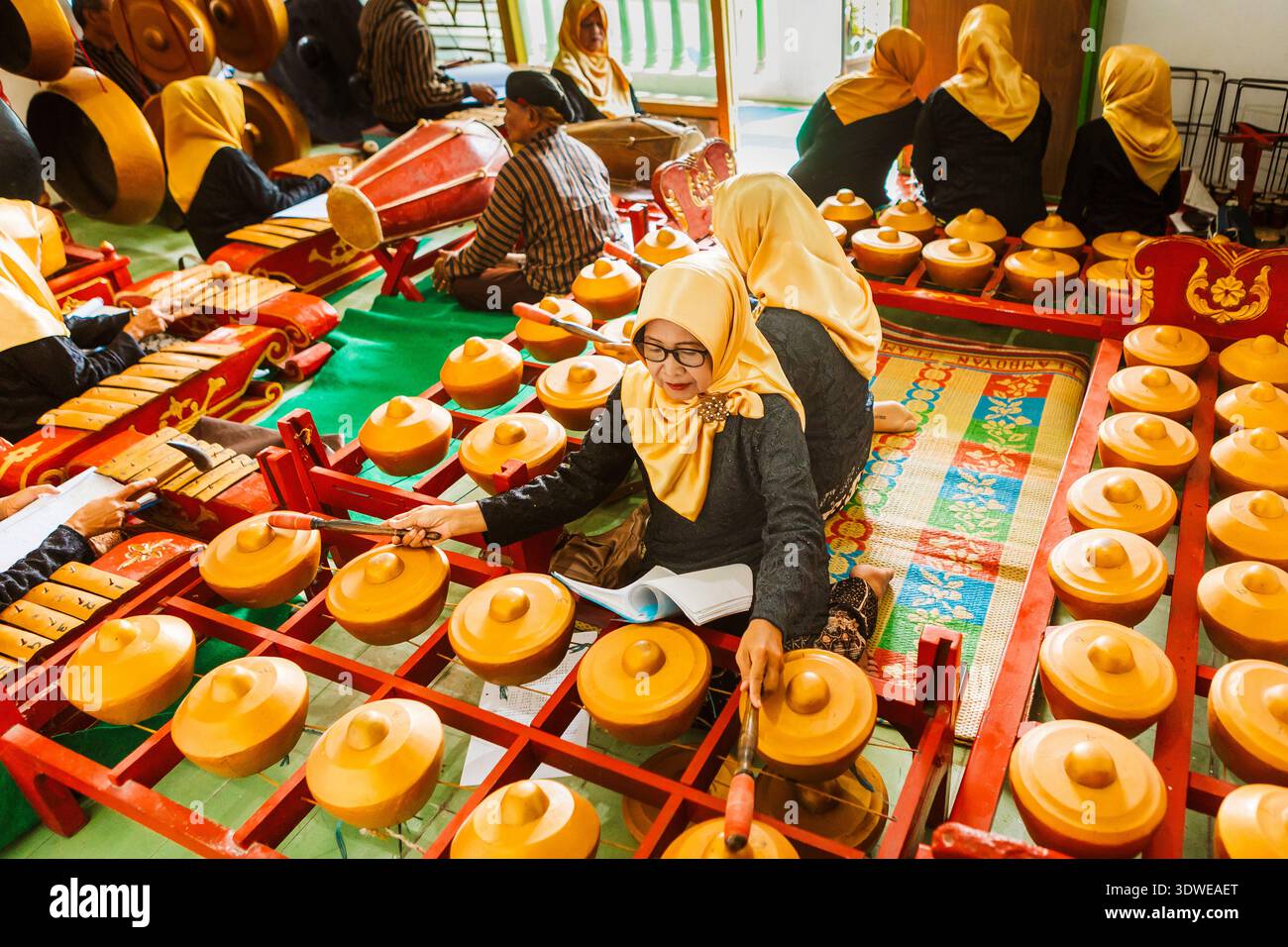 A group of musicians skillfully plays the gamelan, showcasing the rich ...