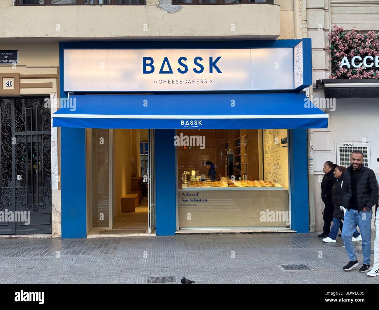Basque Brand BASSK Cheesecakers shop exterior in Valencia, Spain. Bright blue awning ...