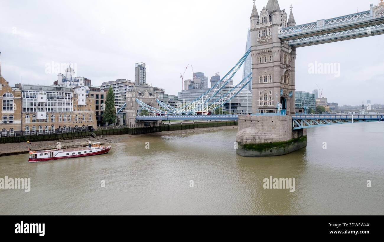 Aerial drone shot capturing the iconic Tower Bridge spanning the Thames ...