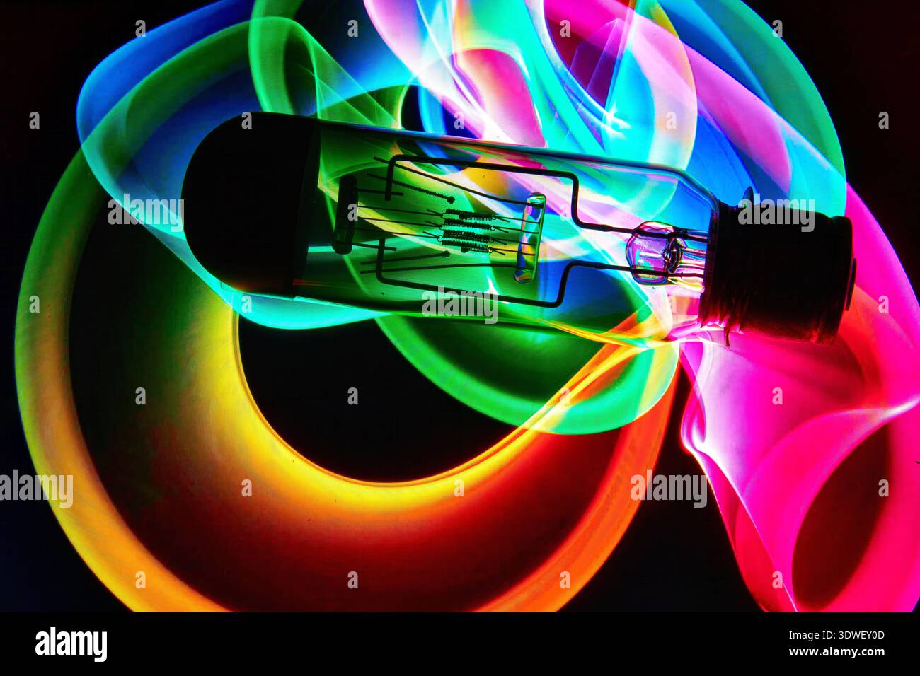 A vacuum tube or light bulb on an abstract colored pattern background. Stock Photo