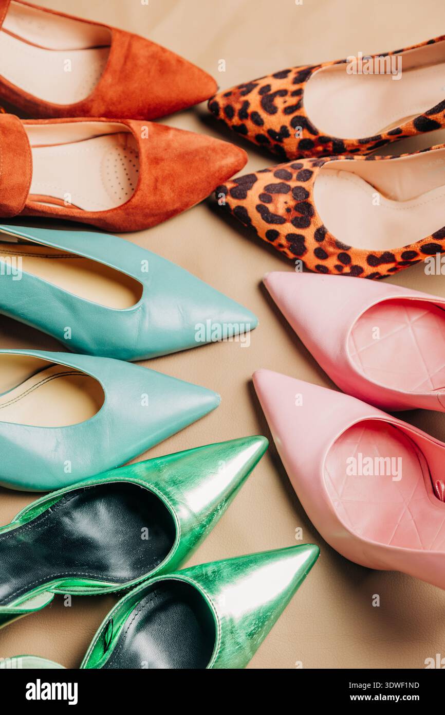 A colorful arrangement of vintage women's shoes in vibrant hues, displayed  on a neutral background. Showcasing styles such as leopard print, suede, an  Stock Photo - Alamy