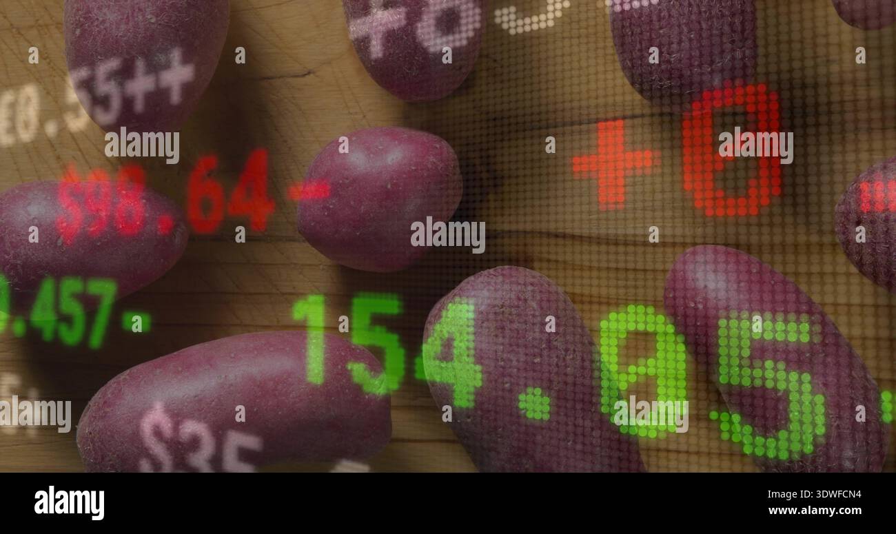 Displaying purple potatoes on wooden cutting board in kitchen, showing LED stock numbers overlay Stock Photo