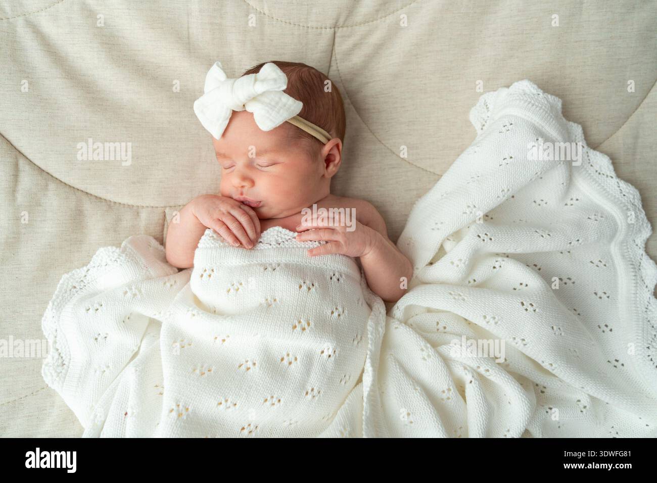 Minimal newborn portrait with white tones and soft lighting. Clean composition suitable for parenting, baby products, and family-related content. Stock Photo