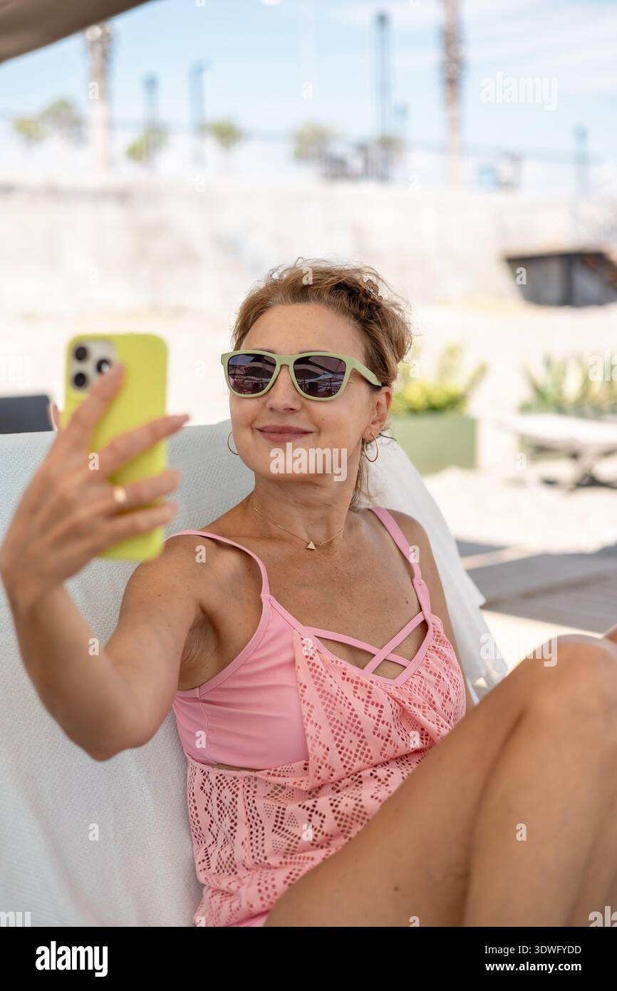 Carefree mature woman sunbathing hi-res stock photography and images ...