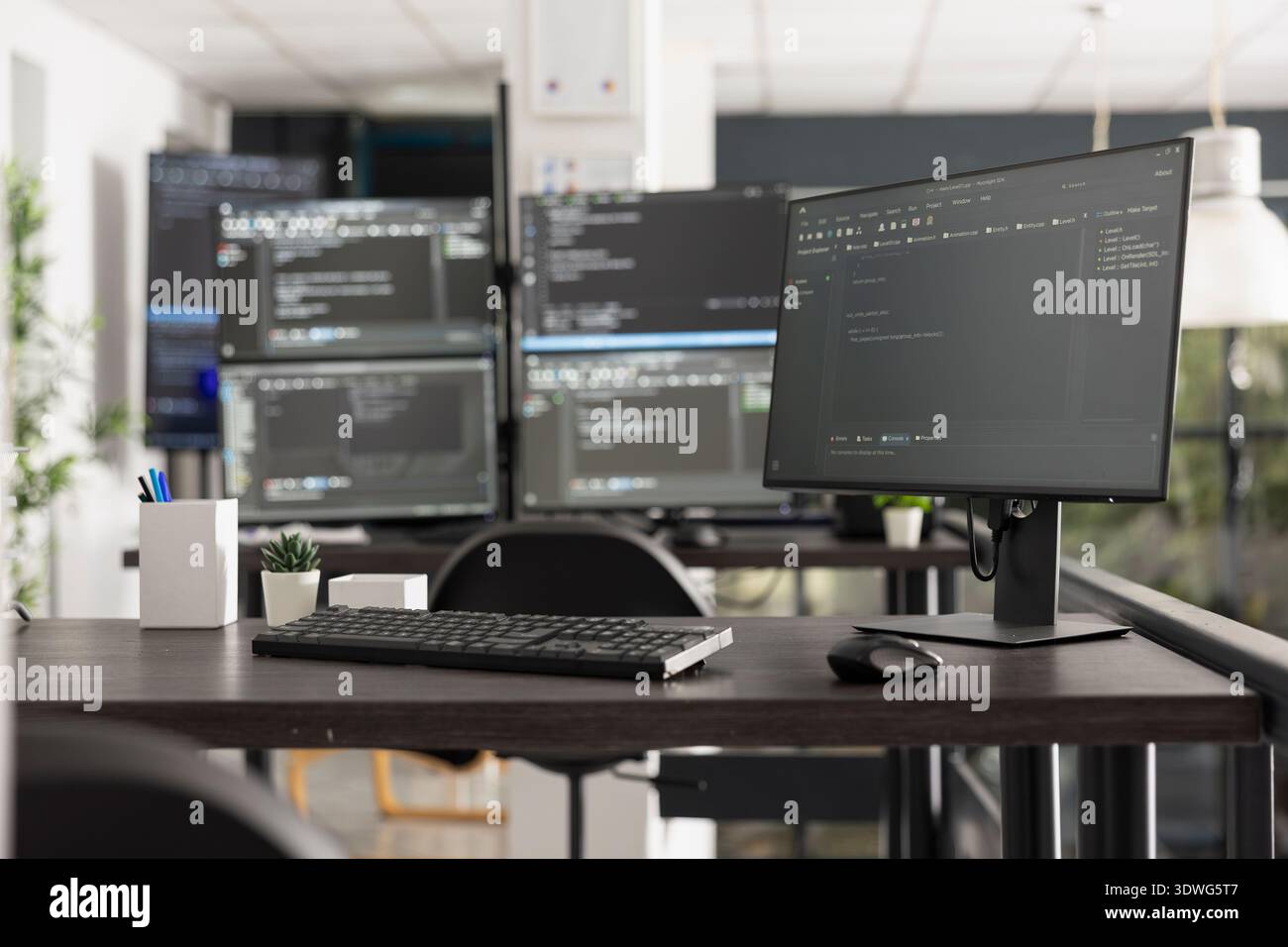 Workspace featuring multiple computer monitors displaying intricate programming code and algorithms, illustrating a developer environment for software engineering and data analysis. Stock Photo