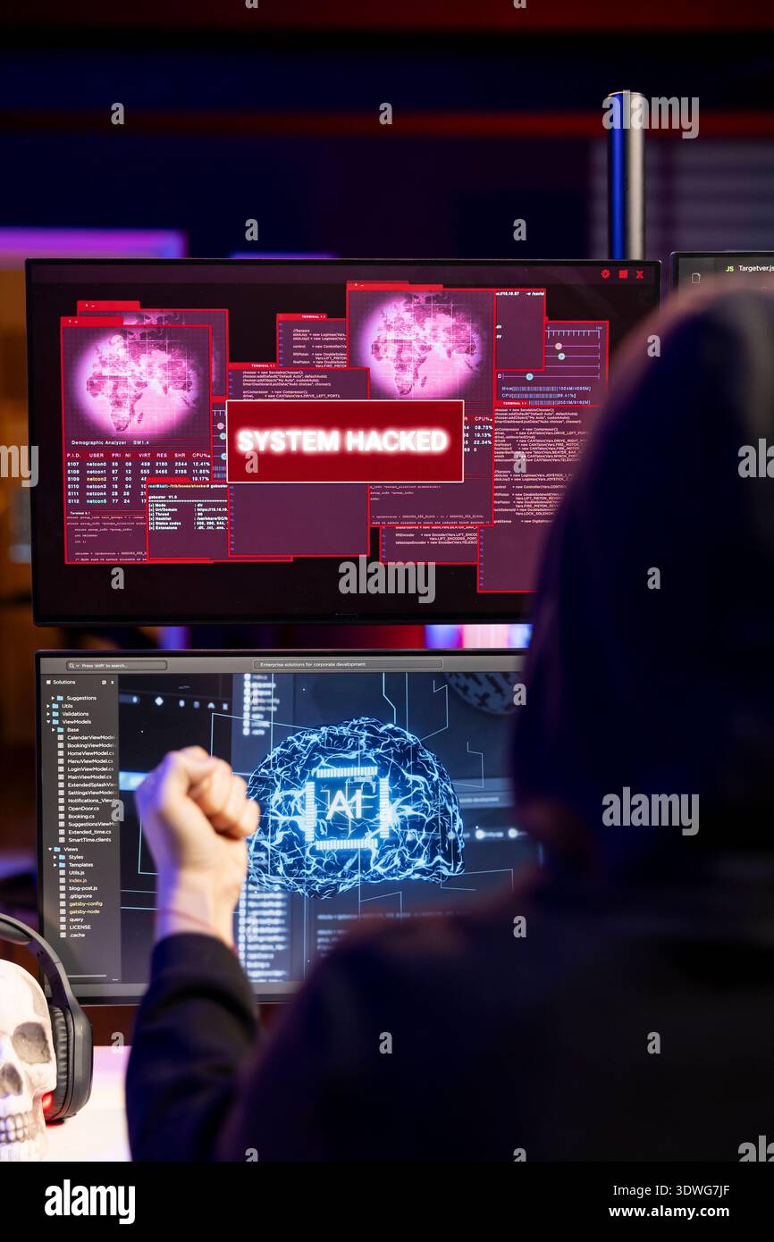 Hacker receiving system hacked message after attacking PCs using AI malware software. Rogue software developer in secret lair trying to hide online activity after stealing data Stock Photo