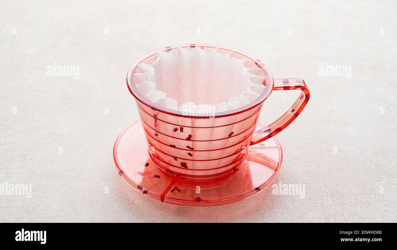 Red coffee dripper with paper filter Stock Photo