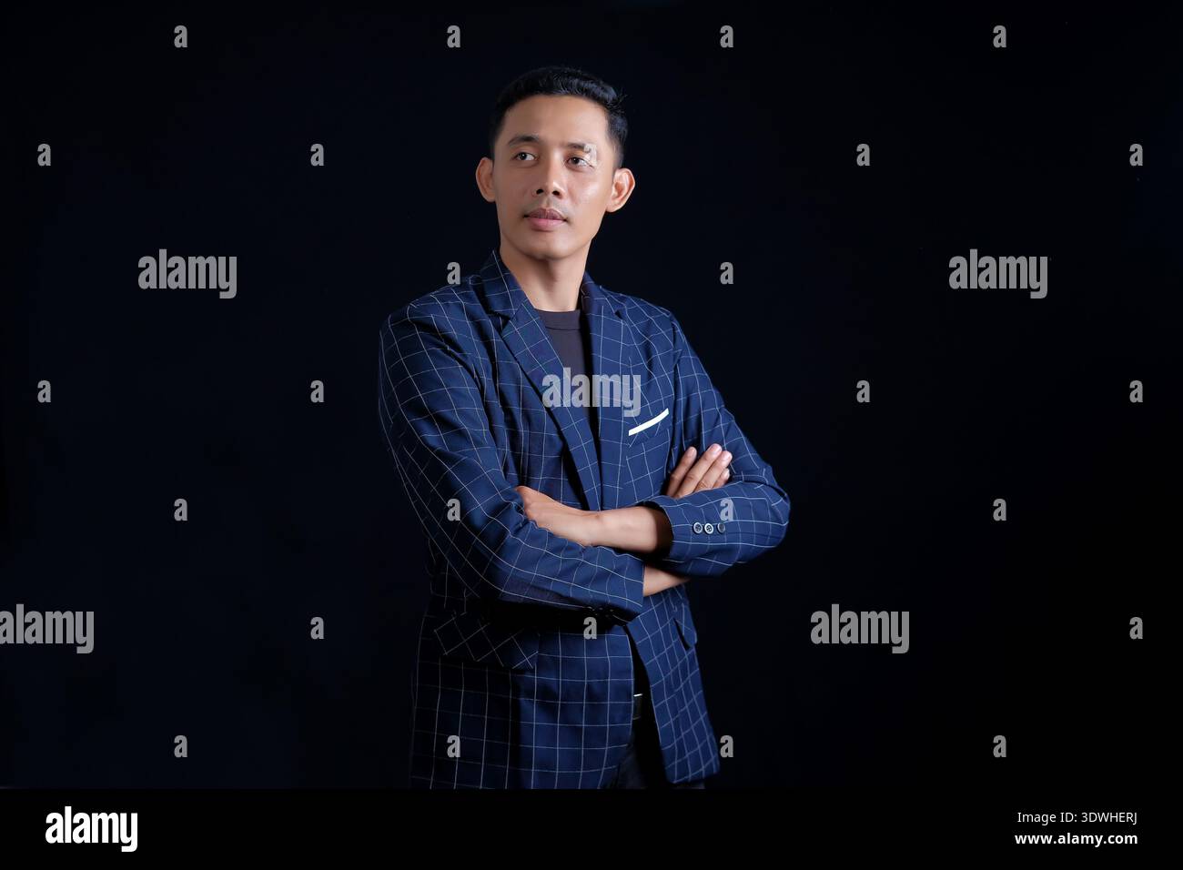 Business man in blue suit on dark background Stock Photo