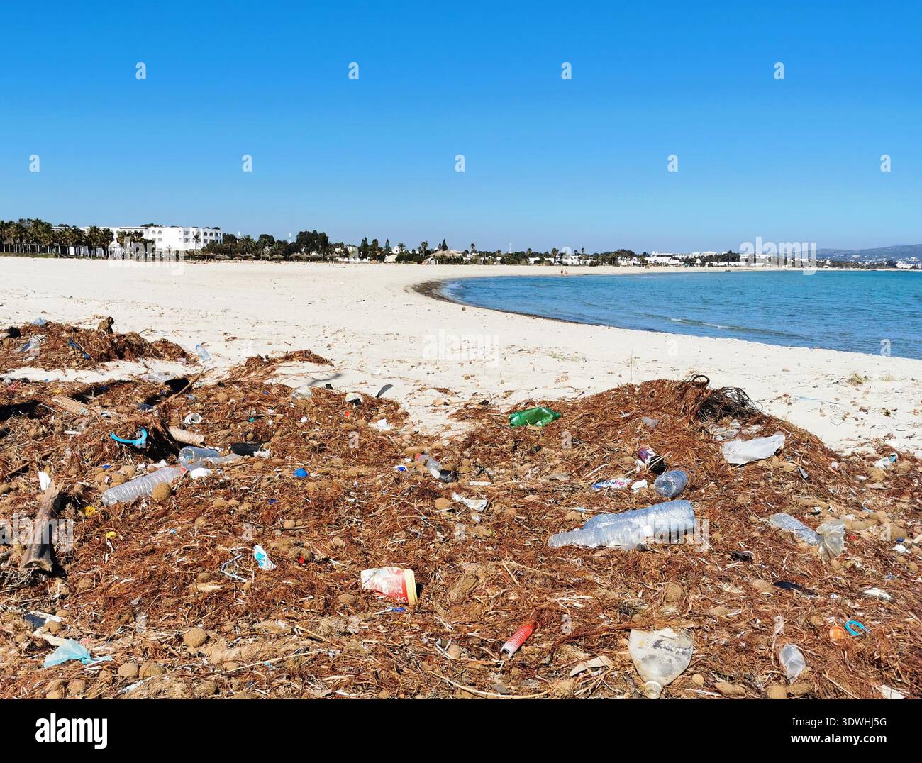 Plastic waste on the beach at Yasmine Hammamet, Tunisia highlighting coastal pollution problem and the urgent need for environmental protection. - Smartphone Captured Stock Image