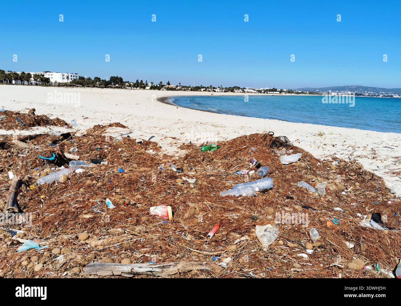 Plastic waste on the beach at Yasmine Hammamet, Tunisia highlighting coastal pollution problem and the urgent need for environmental protection. - Smartphone Captured Stock Image