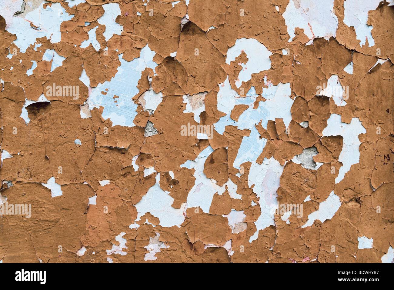 Old wall covered with cracked paint, aging caused by time Stock Photo