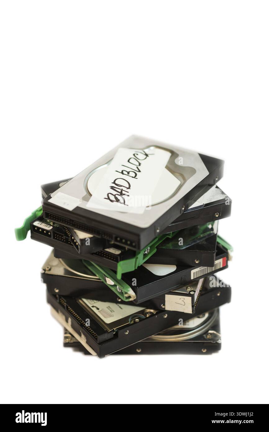 Stack of broken hard disk drives. Isolated on white background Stock Photo