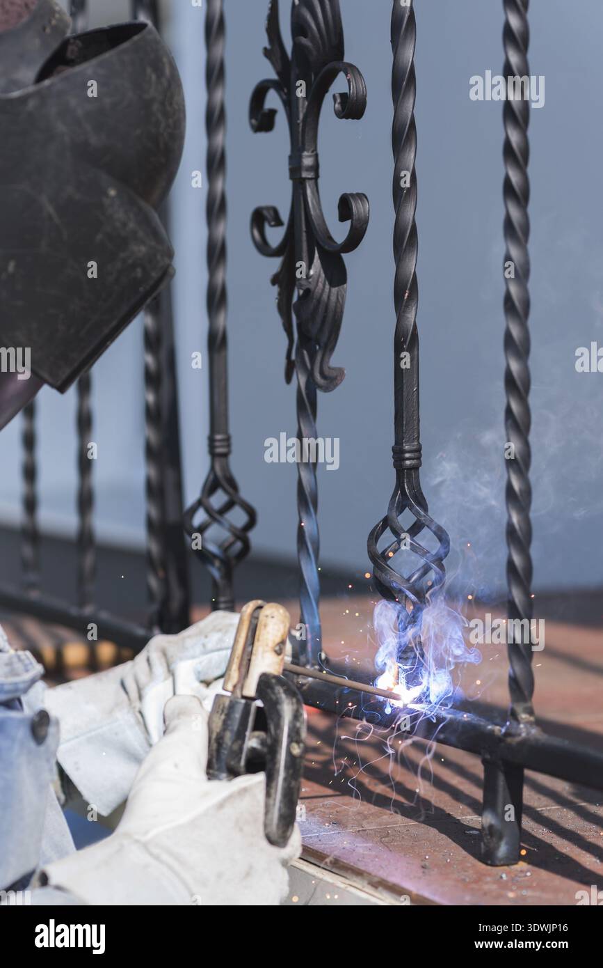 Weldingan Railing Ss A worker welding metal handrails on the stairs. Wrought iron railings ...